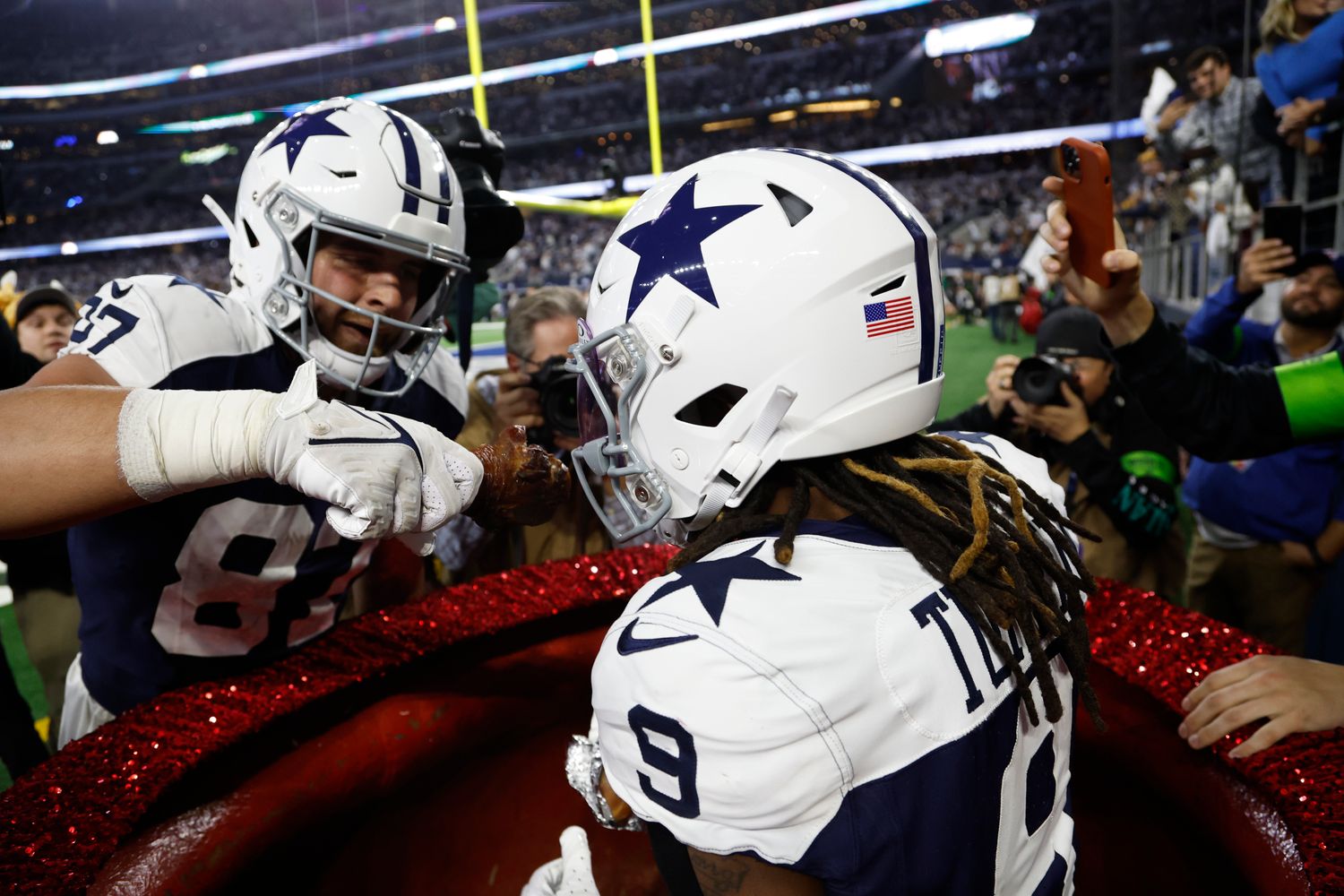 Nov 23, 2023; Arlington, Texas, USA; Dallas Cowboys wide receiver KaVontae Turpin (9) eats a turkey leg as tight end Jake Ferguson (87) feeds him in the fourth quarter against the Washington Commanders at AT&T Stadium. Mandatory Credit: Tim Heitman-USA TODAY Sports